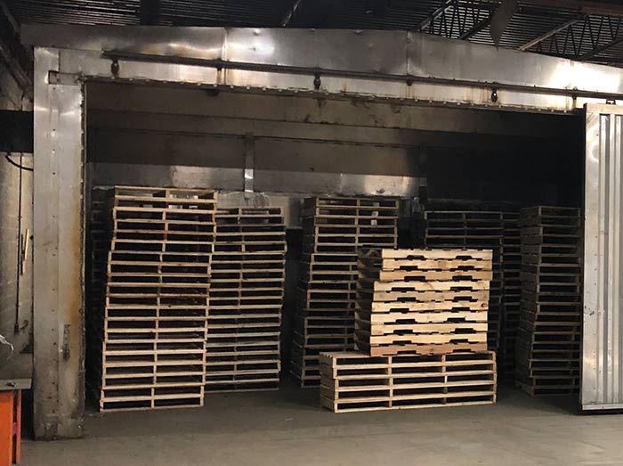 Heat-Treated-Pallet Stack of heat-treated pallets inside a metal structure in Cincinnati, OH